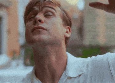 a close up of a man 's neck and face with his eyes closed