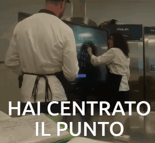 two people standing in front of a screen that says hai centrato il punto on it