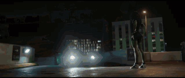 a person is standing in a dark room holding a camera .