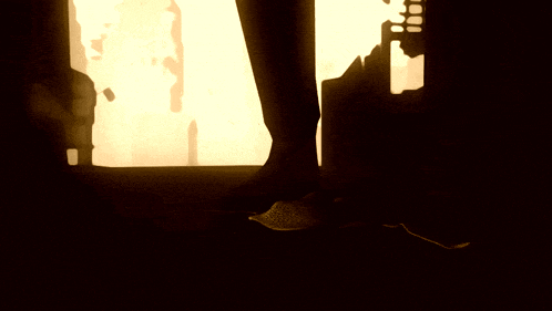 a statue of a man with a crown on his head is in a dark room
