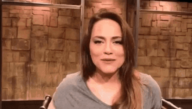 a woman is sitting in front of a microphone in a room .