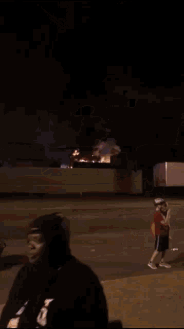 a blurry picture of a person walking down the street at night