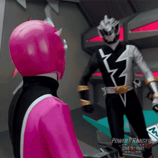 a couple of power rangers are standing next to each other in a room