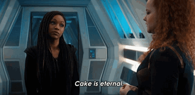 two women standing next to each other and one of them says cake is eternal