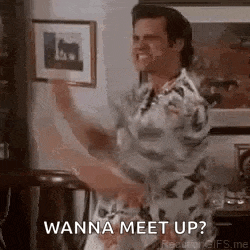 a man in a hawaiian shirt is dancing in a living room while holding a picture .