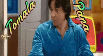 a man in a blue shirt is standing in front of a door that says tomala on it