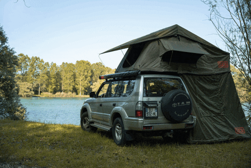 a toyota with a tent on top of it and a license plate that says rtz hl