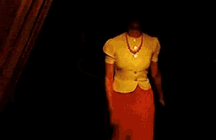 a man and a woman are standing in front of a curtain .