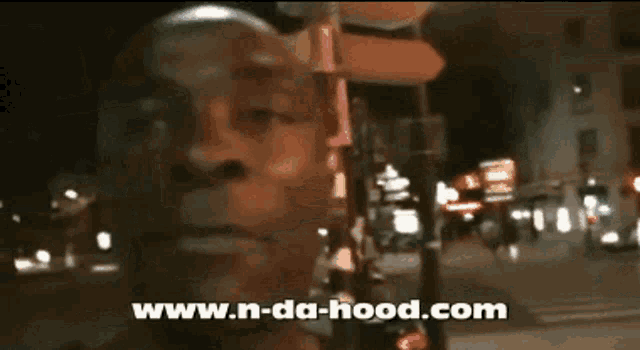 a blurred image of a man with the website www.n-da-hood.com visible