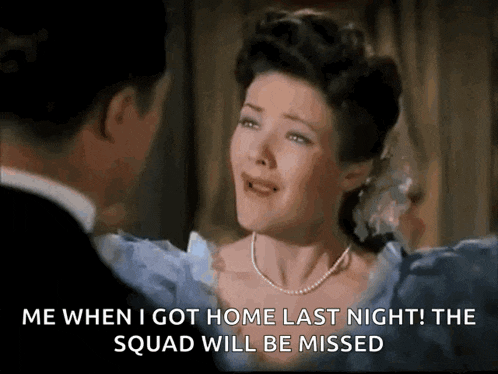 a woman in a blue dress is crying in front of a man in a black suit .