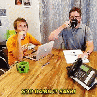 two men are sitting at a table with a phone and a laptop and the words god damn it barb are on the table