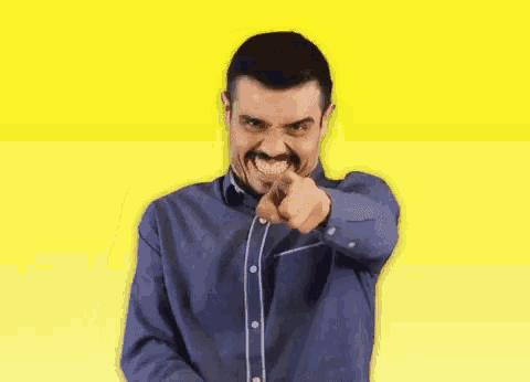 a man with a mustache is covering his mouth with his hands