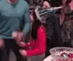 a group of people are standing around a table with a fire extinguisher in the foreground .