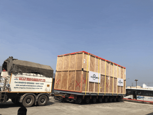 a ballit road carriers pvt ltd truck with a large wooden box on the back