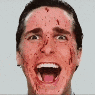 a man with blood on his face and his mouth open