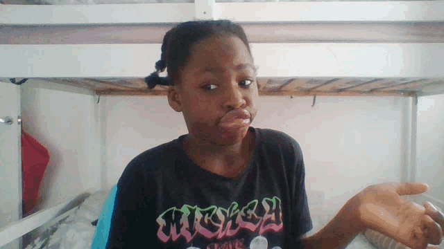a girl wearing a black shirt that says mickey mouse making a funny face