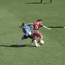 a soccer player with the number 6 on their jersey is trying to get the ball