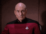 a man in a star trek uniform is drinking from a cup