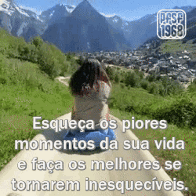 a woman is sitting on a hill with mountains in the background and a quote in portuguese