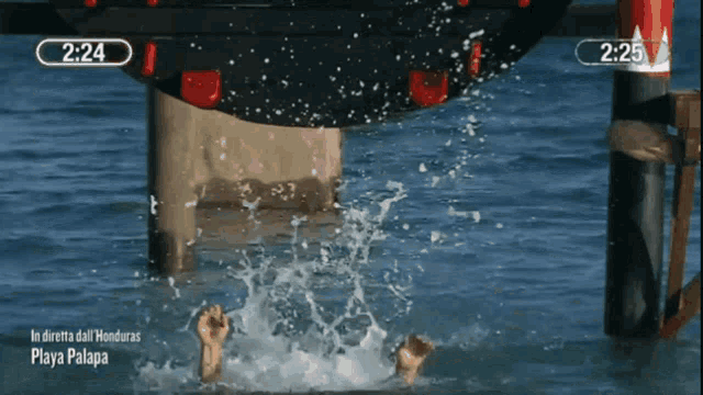 a person 's feet are visible in the water and the time is 2:24