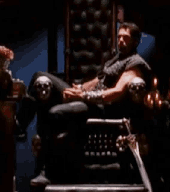 a man is sitting in a chair with a sword and the words " don 't get me wrong " above him
