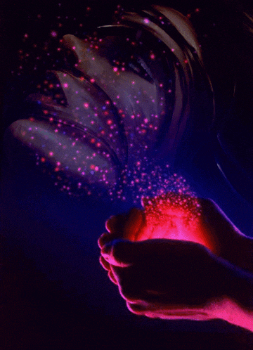 a person holding a light in their hands with a dark background
