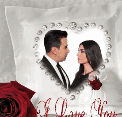 a white pillow with a picture of a man and woman in a heart shaped frame