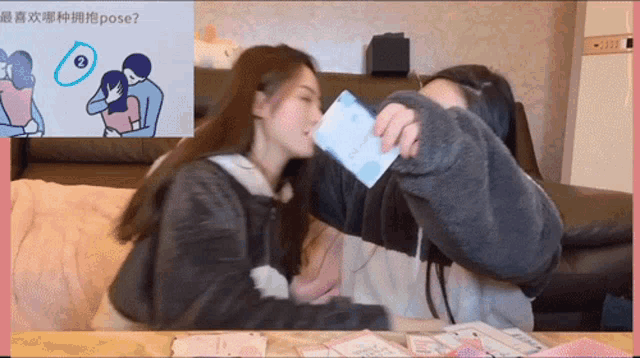 a woman holding a piece of paper in front of a picture of a man and woman hugging