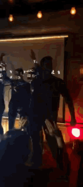 a group of people are dancing in front of a projection screen that says ' a' on it