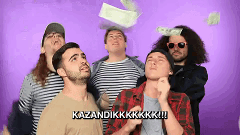a group of men are standing in front of a purple background looking up at money flying in the air .