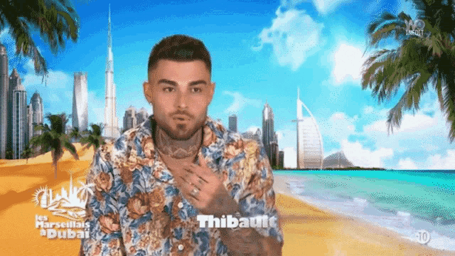 a man in a floral shirt is standing on a beach with the word thibaut on the bottom left