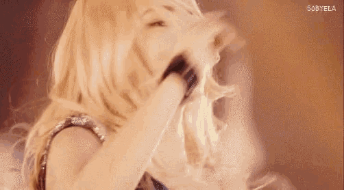 a close up of a woman holding a microphone in her hand .