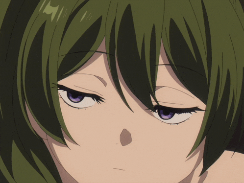 a close up of a person 's face with green hair