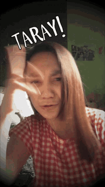 a woman in a plaid shirt is making a funny face with taray written on her face