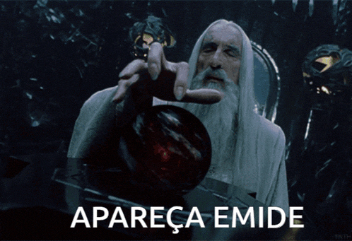 a man with a white beard is holding a red object and the words apareca emide are below him