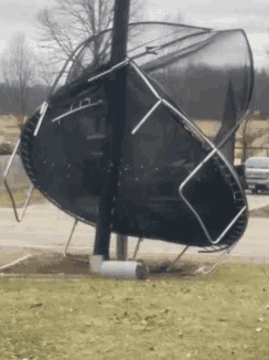 a trampoline is laying on its side on the ground