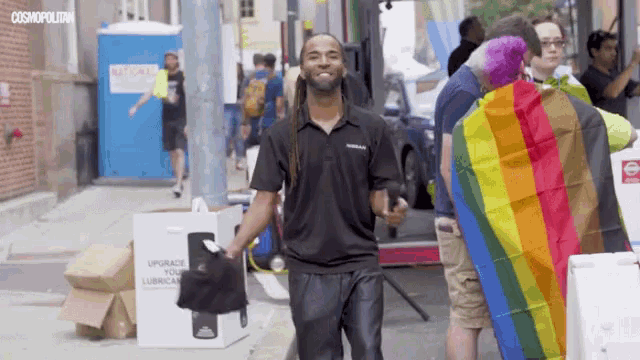 a man walking down a street with a sign that says upgrade your lubricating