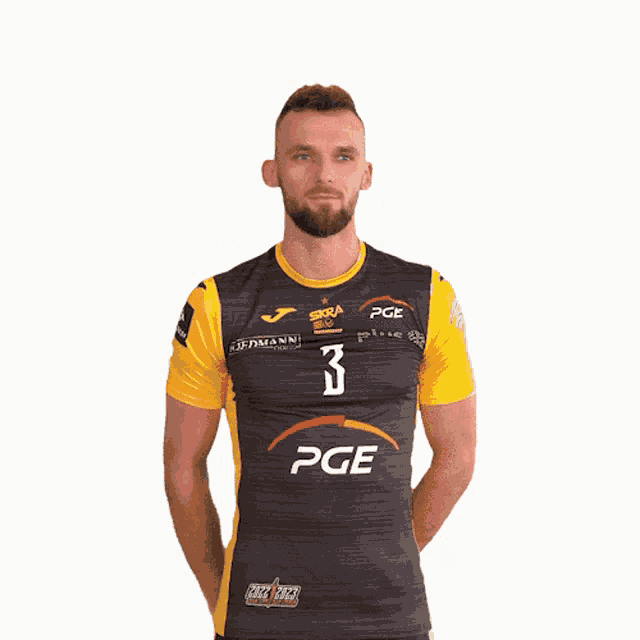 a man wearing a black and yellow shirt with pge on it