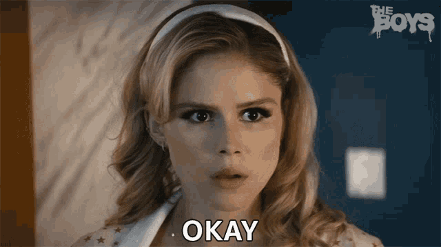 a woman in a white headband says okay