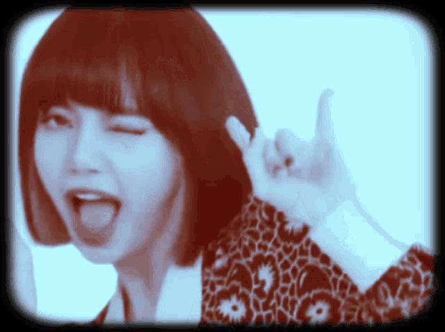 a woman with her tongue hanging out giving a thumbs up sign