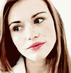 a close up of a woman 's face with long brown hair and pink lips