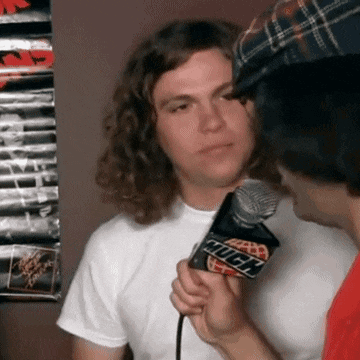 a man talking into a microphone that says rock