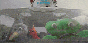 three stuffed animals in a car with a drum that says drum of ban-bang