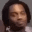 a blurry picture of a man 's face with his eyes closed and a beard .
