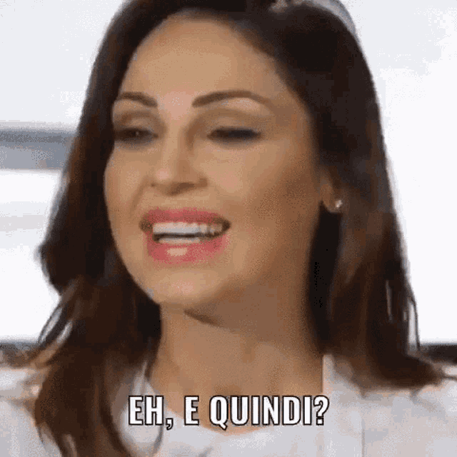 a woman is smiling and saying eh , e quindi ? .