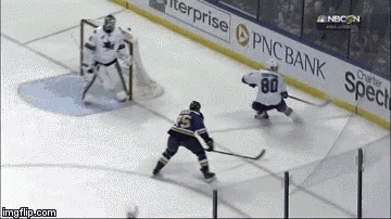 a hockey game is being played in front of a pnc bank sign