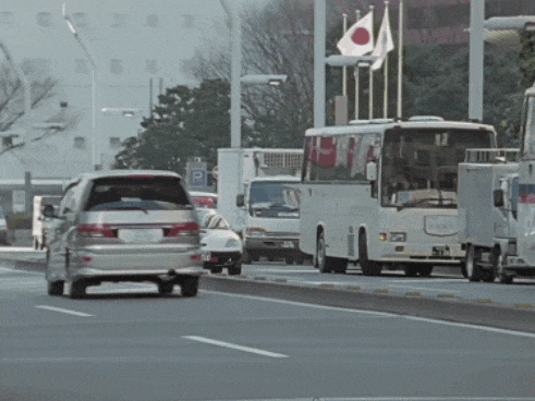 a car with a license plate that says ' a ' on it is driving down the road