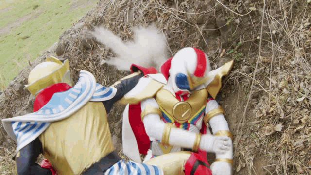 a group of superheros are fighting each other on the ground