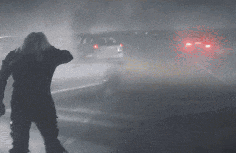 a silhouette of a person standing in a foggy area