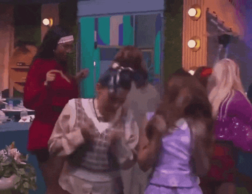 a group of young women are dancing in a room